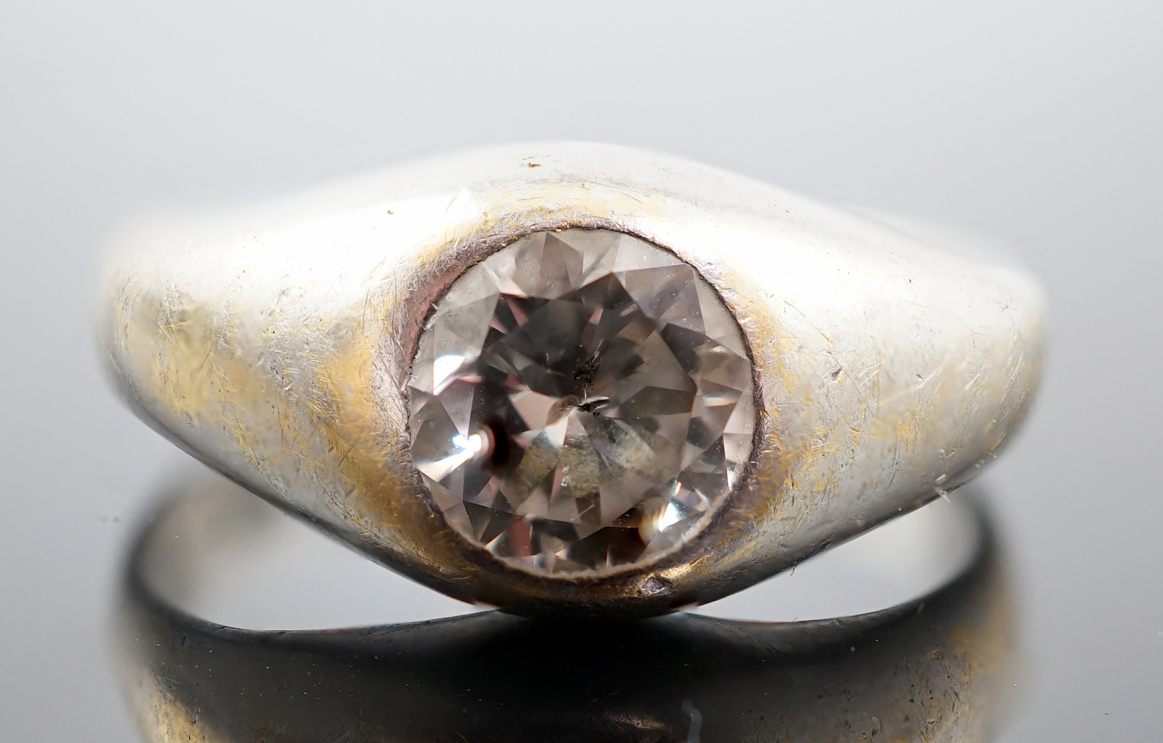 An 18ct white gold and gypsy set solitaire diamond ring
